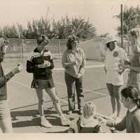 A group of people at the tennis courts