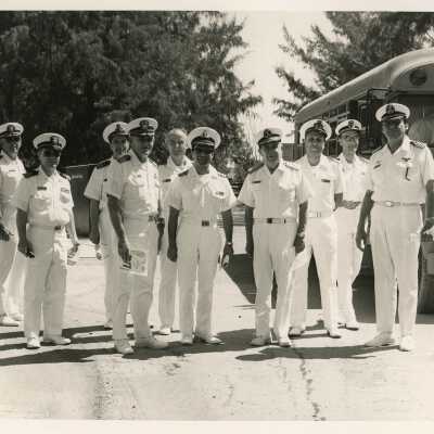U.S. Navy men standing next to a bus