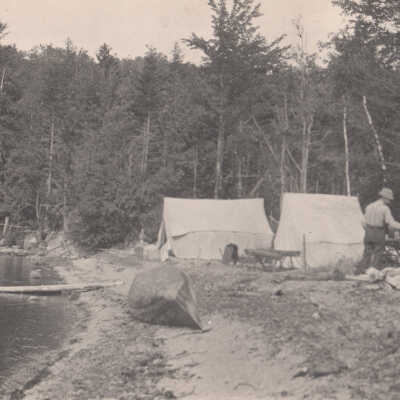 Man with tents and a canoe