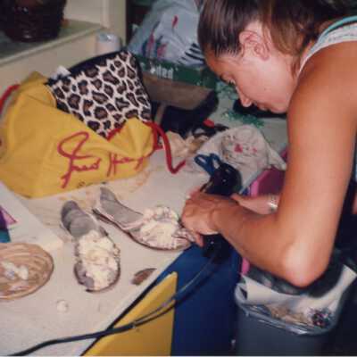 Unknown lady working on shoes.