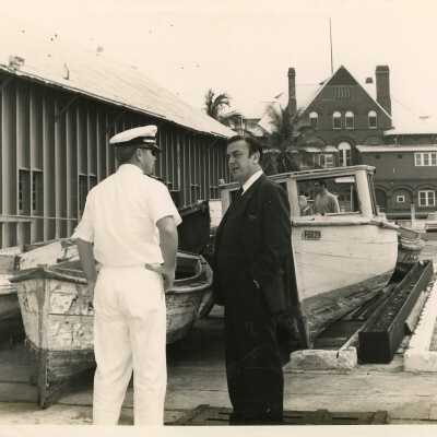 U.S. navy men talking near some boats