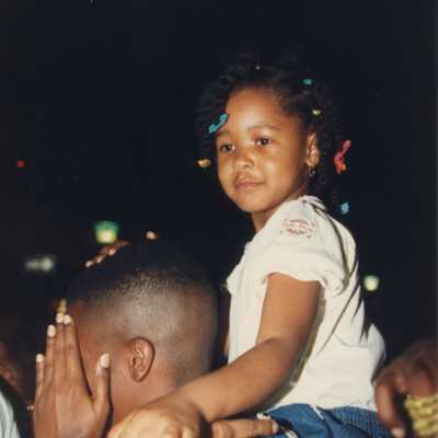Unknown man holding an unknown child on his shoulders.