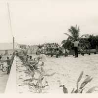 A group of people standing for a picture at the beach