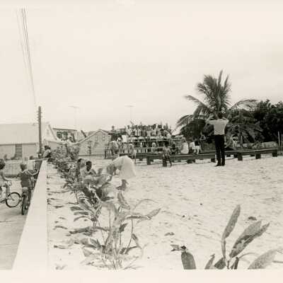 A group of people standing for a picture at the beach