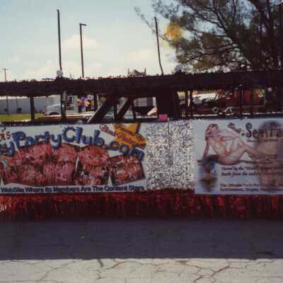A float in the parade that reads Barbi's sexy party club.com.