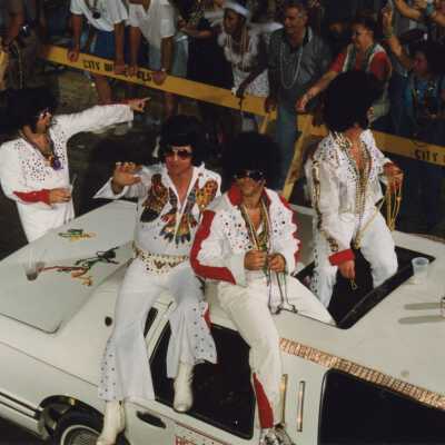 Unknown people dressed up as Elvis on a float in the parade.
