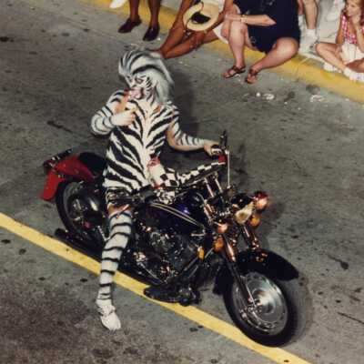 Unknown man dressed up on a motorcycle.