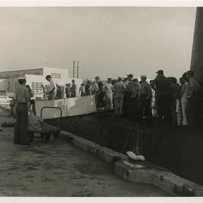 Group of unknown people coming off of a ship