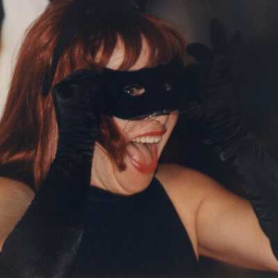An unknown woman dressed up as a black cat.