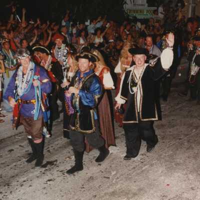 Unknown people dressed up walking in the street for the parade.