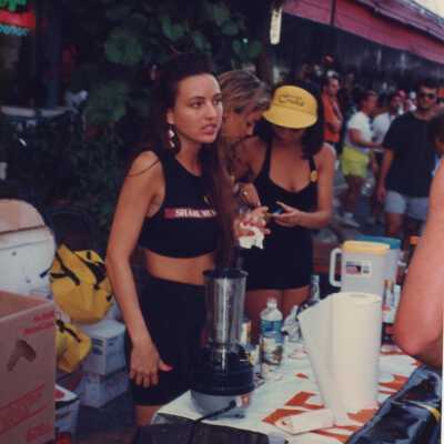 Unknown woman working at the Cristal gold booth.