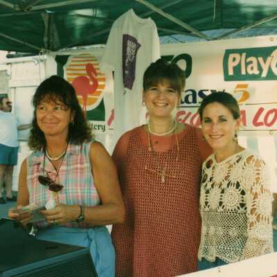Three unknown woman working at the FF booth at the street fair.