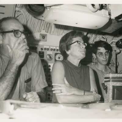 3 Unknown people looking at something in front of them