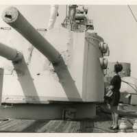 An unknown woman looking at a few men on a machine