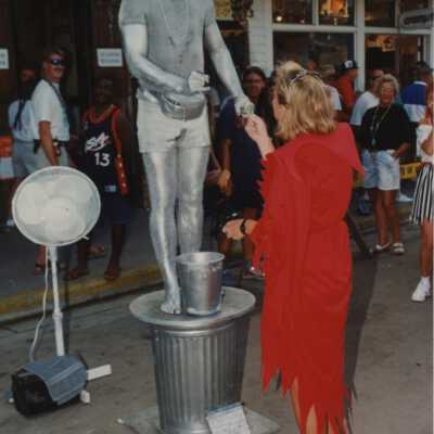 An unknown woman holding the Silver man's hand.