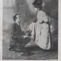          Man kneeling with a shoe
   