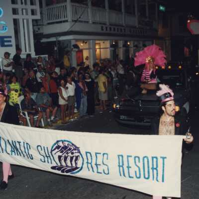 Two unknown people holding the Atlantic Shores resort banner.