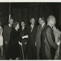 A group of unknown people at a party greeting each other