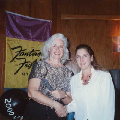 Two unknown woman at an award ceremony.