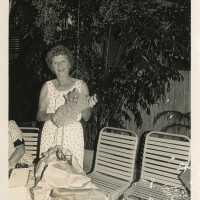 A lady holding a cat sculpture