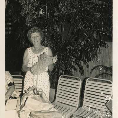 A lady holding a cat sculpture