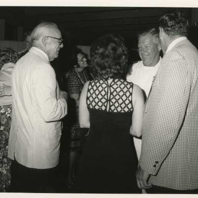 Unknown people talking at a party