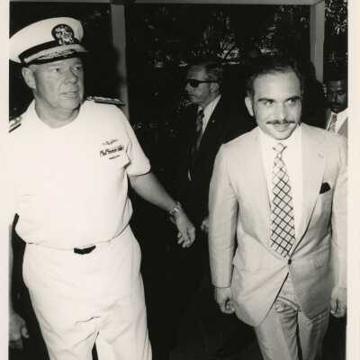 U.S. Navy man walking with unknown man