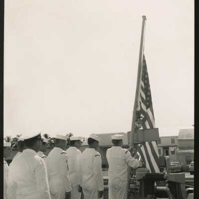 U.S. Navy men with a flag