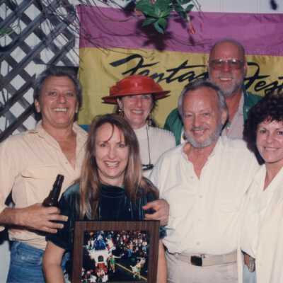 Unknown people accepting an award at the award ceremony.