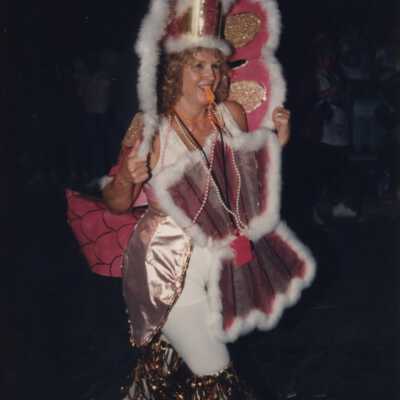 Unknown woman dressed up walking in the parade.