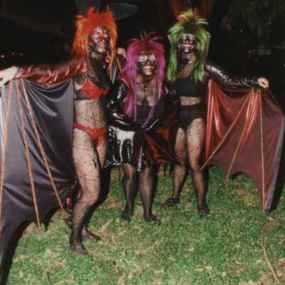 Three unknown people dressed up.