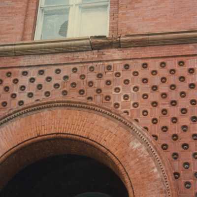 A brick arch and second floor window.