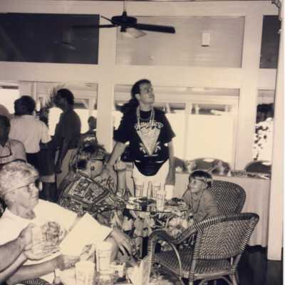 Unknown people sitting around at a few tables.