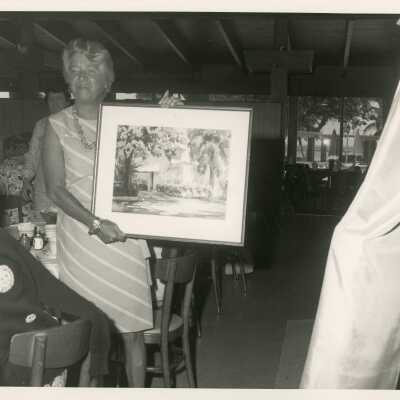 An unknown woman showing of an art piece