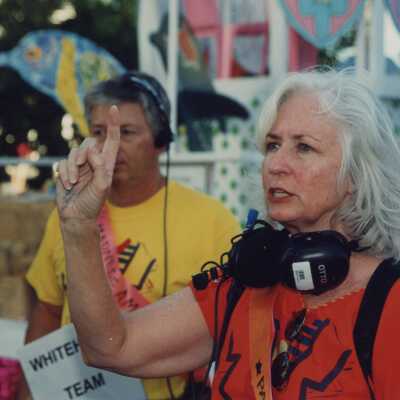 An unknown woman who is one of the parade monitors.
