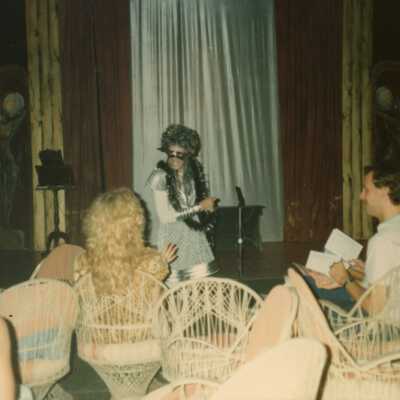 Unknown people sitting facing a stage.