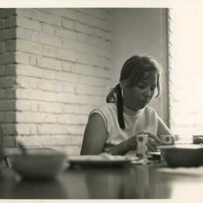 Unknown lady eating at a table