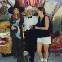 Capt. Tony and two unknown woman standing with a float.
