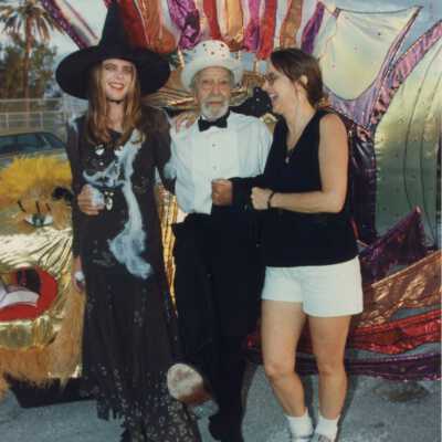 Capt. Tony and two unknown woman standing with a float.