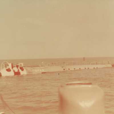 U.S. Navy men standing by a ship