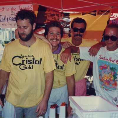 Four unknown men working at the Cristal gold booth.