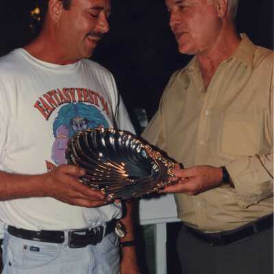 Two unknown men holding an award at the awards ceremony.