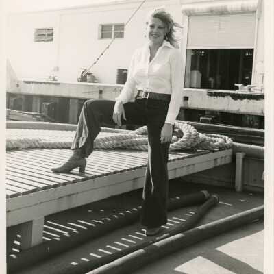 Unknown woman standing by a dock