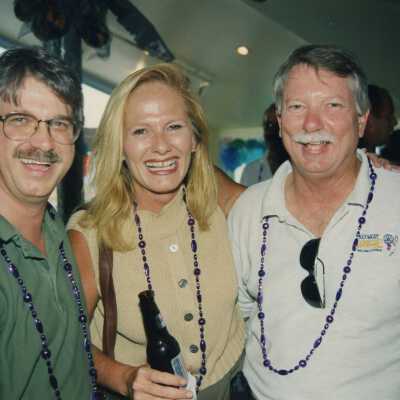 Three unknown people at a ceremony.
