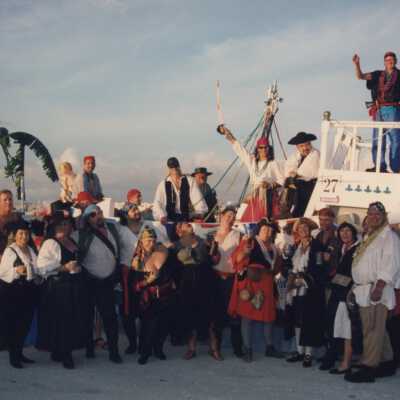 Unknown people standing in front of float number 27.