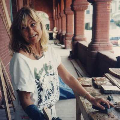 An unknown woman working on terra cotta on the porch.