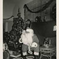 An unknown child sitting on Santa