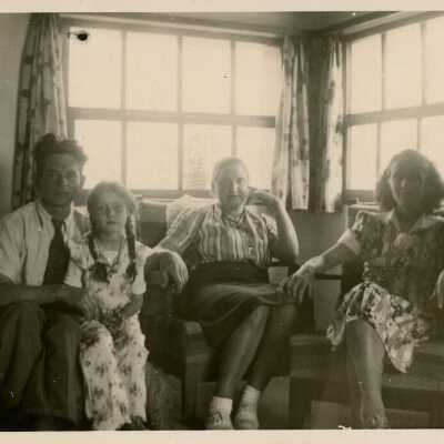 Unknown people sitting in a living room