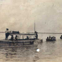 Boats taking men to work on the railroad