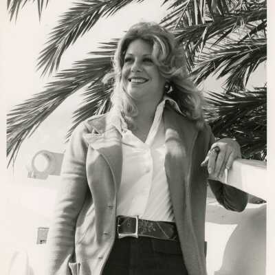 Unknown woman leaning against a wall